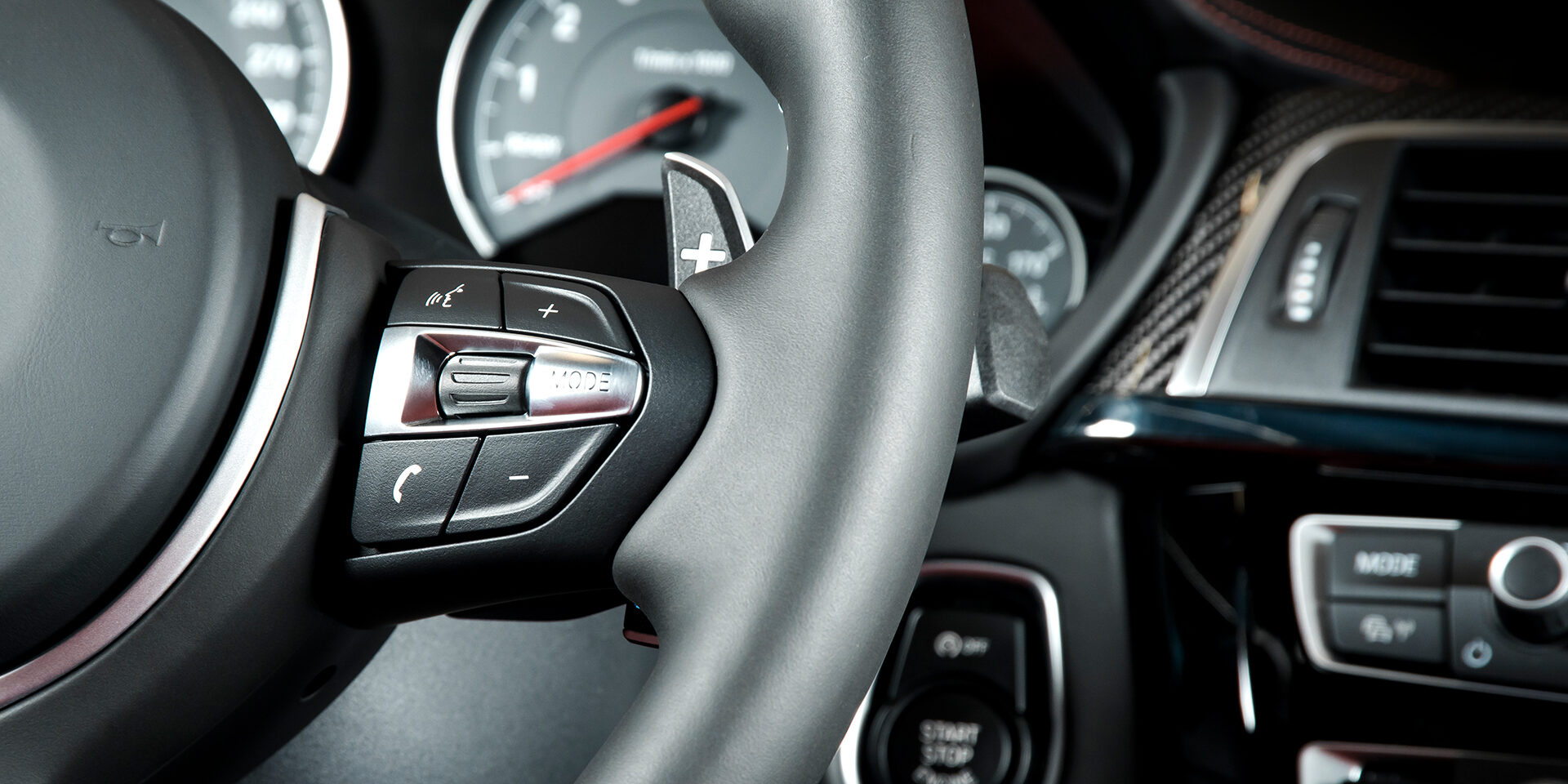 media control buttons on the steering wheel, modern luxury car interior details
